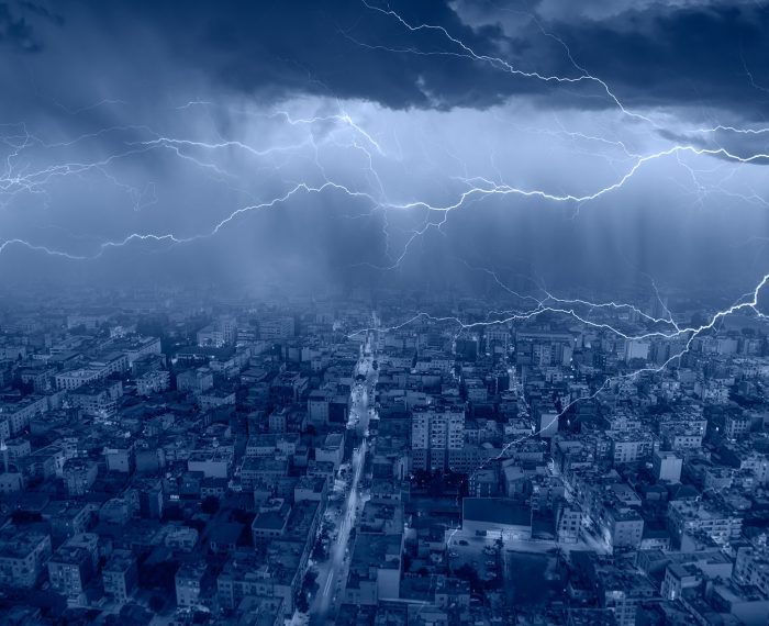 Lightning thunderstorm flash over the city at blue night sky - L